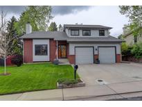 Charming two-story home with a well-manicured lawn and a two-car garage at 66 Yank Way, Lakewood, CO 80228