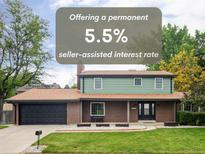 Charming two-story home boasts a lush lawn and a welcoming brick and siding exterior at 6982 Estes Dr, Arvada, CO 80004