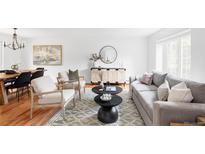 Bright living room with stylish decor, comfortable seating, and natural light from the window at 6982 Estes Dr, Arvada, CO 80004