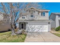Charming two-story home with a well-manicured lawn, mature tree and a two car garage at 9508 Elk Mountain Cir, Littleton, CO 80125