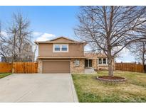 Charming two-story home with a well-maintained lawn and a two car garage at 7604 S Lamar Ct, Littleton, CO 80128