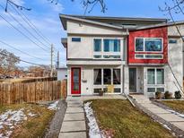 Modern two-story home with red and white exterior, landscaping, and walkway at 4390 Osage St, Denver, CO 80211