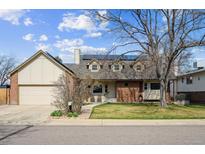 Charming two-story home featuring a well-manicured lawn, brick accents and solar panels on the roof at 10622 Van Gordon Way, Broomfield, CO 80021