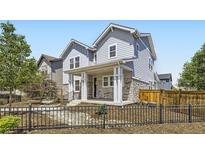 Charming two-story home boasts stone accents, a welcoming front porch, and a beautifully landscaped yard at 9111 W 100Th Way, Broomfield, CO 80021