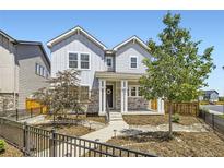 Charming two-story home featuring stone accents, landscaped yard, and inviting front porch at 9111 W 100Th Way, Westminster, CO 80021