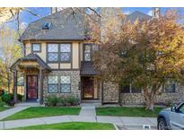 Charming townhome featuring a stone facade and mature landscaping at 18508 E Whitaker Cir # D, Aurora, CO 80015