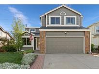Charming two-story home boasts a well-manicured lawn, attached two car garage, and beautiful landscaping at 180 S Carlton St, Castle Rock, CO 80104
