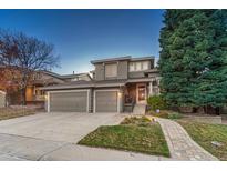 Two-story house with attached garage and landscaped yard at 10073 Blackbird Pl, Highlands Ranch, CO 80130