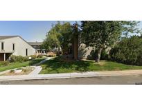 Landscaped condo building with mature trees, a walkway and a grassy lawn at 3548 S Hillcrest Dr # 2, Denver, CO 80237