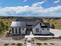 Stunning modern farmhouse with professionally landscaped front yard and mountain views at 8263 Merryvale Trl, Parker, CO 80138