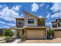 Beautiful two-story home with a modern design, landscaped front yard, and an attached two-car garage at 13589 E 102Nd Pl, Commerce City, CO 80022