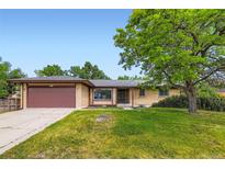 Charming one story ranch home featuring a two-car garage and mature landscaping at 2122 S Yank Way, Lakewood, CO 80228