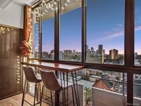 Cozy balcony featuring a wooden counter, bar stools, and stunning city views at 800 N Pearl St # 709, Denver, CO 80203