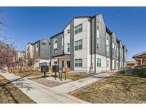 Modern condo building featuring gray and white siding, clean lines, and well-maintained landscaping at 1810 Irving St # 4, Denver, CO 80204