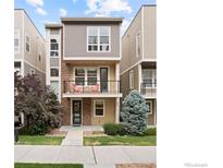 Charming three-story townhome with stone accents, balcony, and well-maintained landscaping at 524 E Hinsdale Ave, Littleton, CO 80122