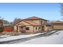 Charming two-story home featuring stucco siding, red tile roof, and a detached garage at 454 S Eaton St, Lakewood, CO 80226