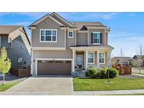 Charming two-story home with a well-manicured lawn and a two-car garage, perfect for Gathering living at 502 Green Mountain Dr, Erie, CO 80516