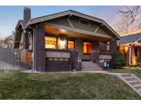 Charming brick home featuring a cozy front porch and well-maintained landscaping at 3044 W 37Th Ave, Denver, CO 80211