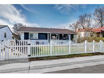 Charming home featuring a white picket fence and well-maintained front yard with a covered entryway at 4070 W Exposition Ave, Denver, CO 80219