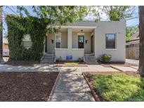 Charming duplex featuring beautiful brickwork and lovely landscaping at 914 E Iowa Ave, Denver, CO 80210
