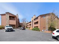 Inviting condo community showcasing well-maintained buildings, assigned parking, and attractive landscaping against a clear blue sky at 4681 S Decatur St # 227, Englewood, CO 80110