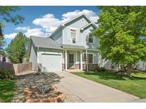 Charming two-story home featuring a well-maintained lawn and inviting curb appeal on a sunny day at 6142 Gorham St, Frederick, CO 80530