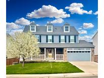 Charming two-story home with a landscaped front yard and a two-car attached garage at 9954 Heywood St, Highlands Ranch, CO 80130