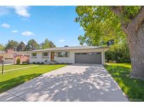 Charming one-story home with a well-manicured lawn, attached garage, and inviting curb appeal at 13402 W 24Th Pl, Golden, CO 80401