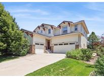 Beautiful two-story home with a three-car garage and well-maintained lawn at 17298 E Lake Pl, Aurora, CO 80016