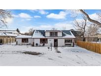 Snow covered front yard, charming one-story home with a classic design at 3699 Teller St, Wheat Ridge, CO 80033