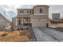 Charming two-story home with a covered porch and two-car garage at 42729 Ivydel Cir, Elizabeth, CO 80107
