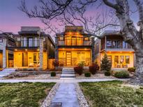 Charming three-story modern home with landscaped front yard at dusk at 3711 Mariposa St, Denver, CO 80211