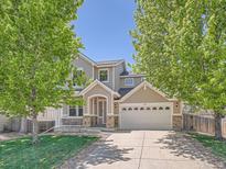 Inviting two-story home with a well-manicured lawn, charming porch, and a two car garage at 12653 Jersey E Cir, Thornton, CO 80602