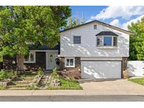 Charming two-story home with a brick and siding exterior, plus a two car garage and front yard at 5831 W 108Th Pl, Westminster, CO 80020