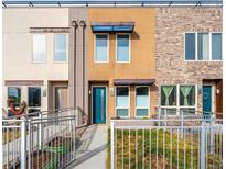 Modern townhome featuring a charming walkway and colorful front door at 1581 Wolff St, Denver, CO 80204