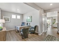 Bright home office with two chairs, stylish desk, hardwood floors, and lots of natural light at 4837 Cattle Cross Ln, Castle Rock, CO 80104