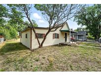 Cozy one-story home with a mature tree in the front yard offering shade at 12 Marshall Pl, Longmont, CO 80504
