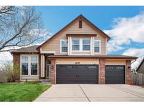 Charming two-story home features a well-maintained front yard and attached two car garage at 2649 S Kline Cir, Lakewood, CO 80227