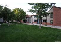 Beautifully landscaped townhomes with lush green lawns and mature trees at 12033 E Harvard Ave # 208, Aurora, CO 80014