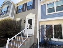 Inviting townhouse with a charming front door and well-maintained landscaping at 10561 W Dartmouth Ave, Lakewood, CO 80227