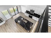 Modern kitchen features white cabinets, stainless steel appliances, and a black marbled island countertop at 6519 Pinewood Dr, Parker, CO 80134
