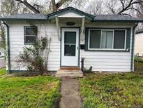 Charming home with a covered entrance and well-maintained lawn, offering a welcoming curb appeal at 5899 Vance St, Arvada, CO 80003
