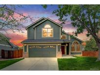 Charming two-story home featuring an attached garage, well-maintained lawn, and vibrant landscaping at 6735 W 97Th Cir, Westminster, CO 80021