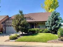 Charming single-Gathering home featuring a lush, green lawn and well-maintained landscaping at 10553 Adams St, Northglenn, CO 80233