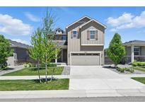 Charming two-story home featuring a well-manicured lawn and attached two-car garage at 27125 E Bayaud Ave, Aurora, CO 80018