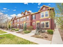 Charming townhome exterior featuring colorful siding, landscaped front yard, and welcoming entryway at 600 Avalon Ave, Lafayette, CO 80026