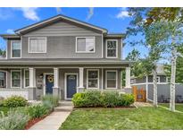 Charming gray two-story home with well-maintained lawn, landscaping, and inviting blue front door at 3937 Osceola St, Denver, CO 80212