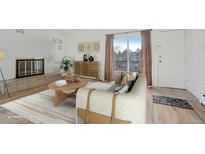 Bright living room features a cozy fireplace, stylish decor, and plenty of natural light at 250 N Pearl St # 310, Denver, CO 80203