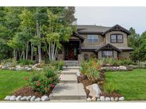 Beautifully landscaped front yard with flower beds leading to this charming home's entrance at 2121 Jade Way, Longmont, CO 80504