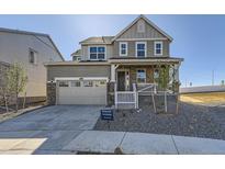 Charming two-story home with stone accents, covered porch, and attached two-car garage at 2184 S Gold Bug Ct, Aurora, CO 80018